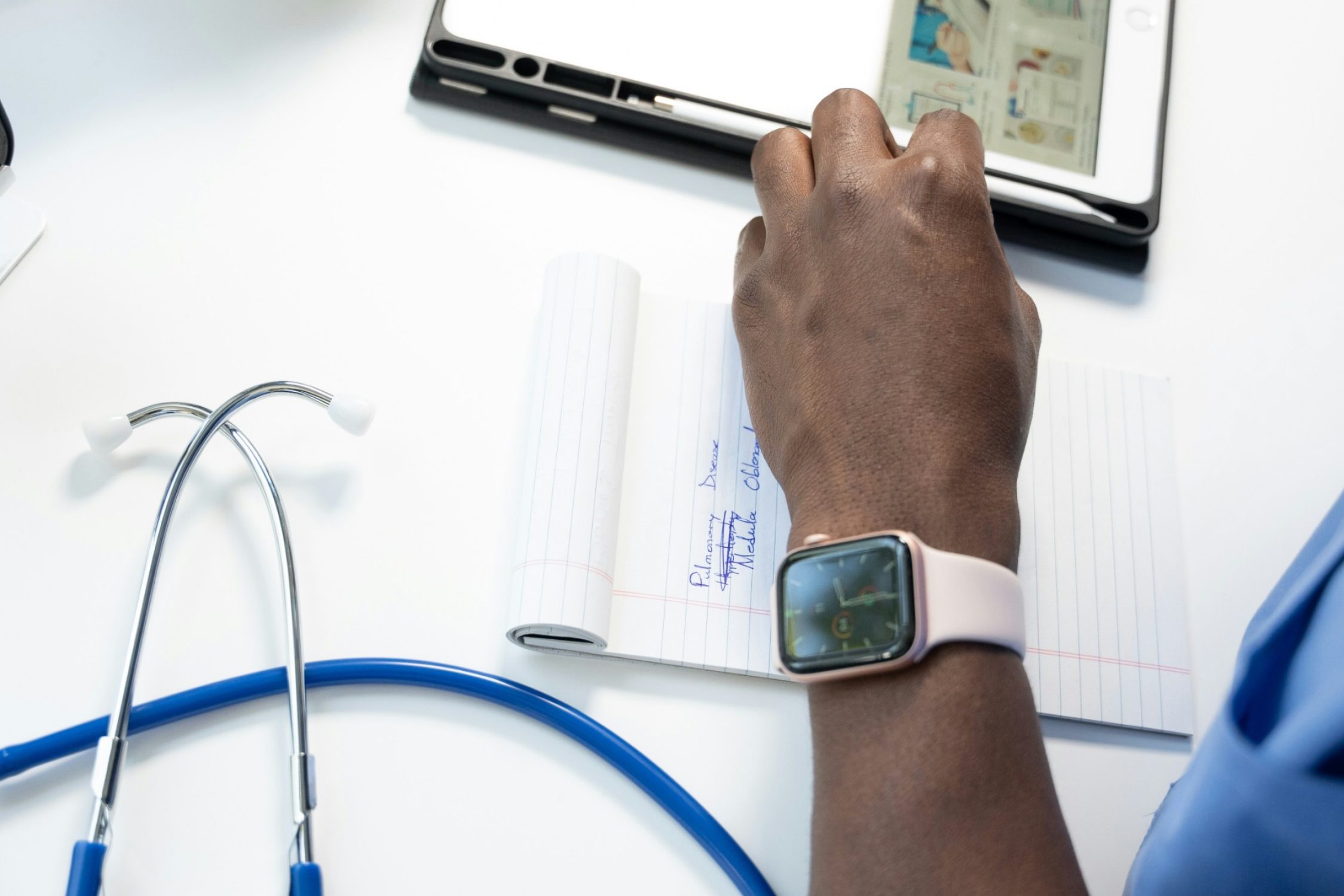 A doctor makes a note of something